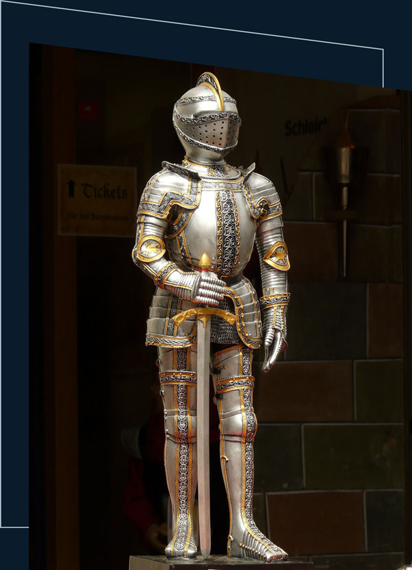 Knight armour standing with a sword in a museum.